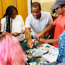 Teaching Fellow and students working on a project at Knowles Teacher Initiative